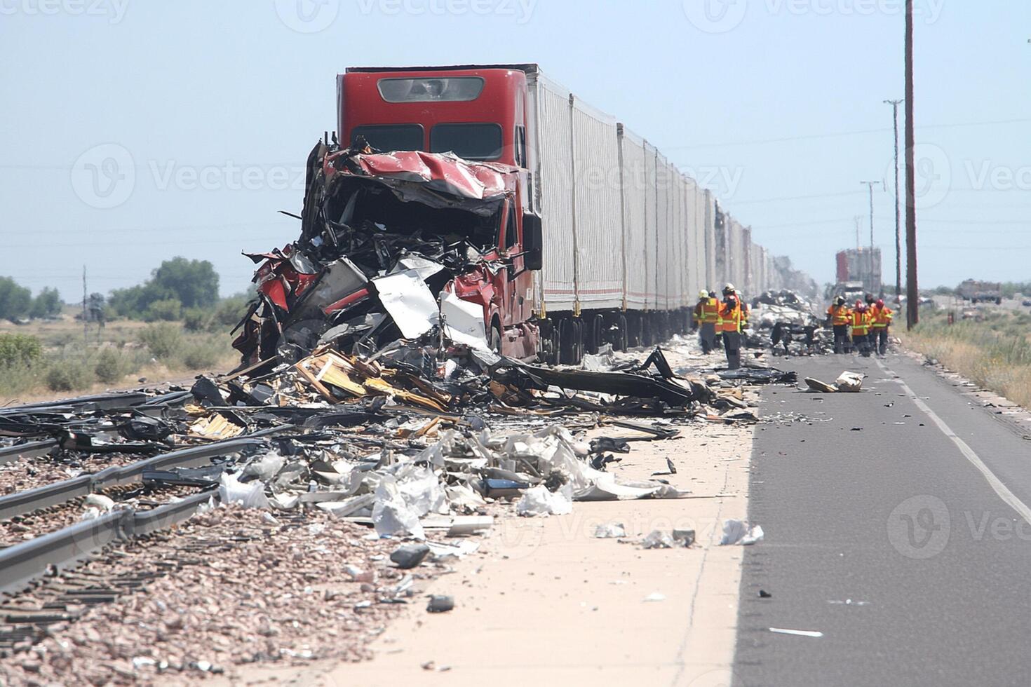 A train is on the side of the road with a lot of debris photo