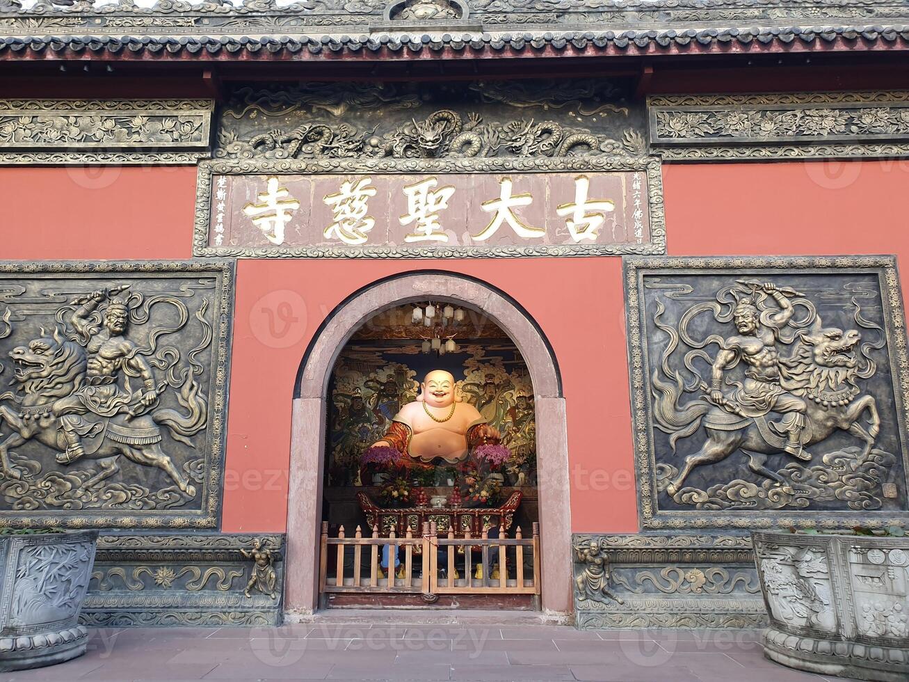 a buddha statue in front of a chinese temple photo