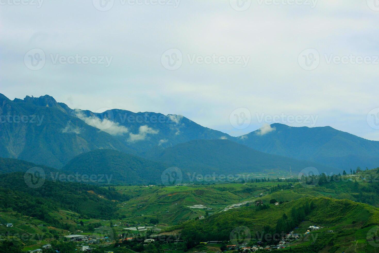 Scenic Mountain Landscape with Green Valleys and Misty Peaks in Kundasang, Borneo photo