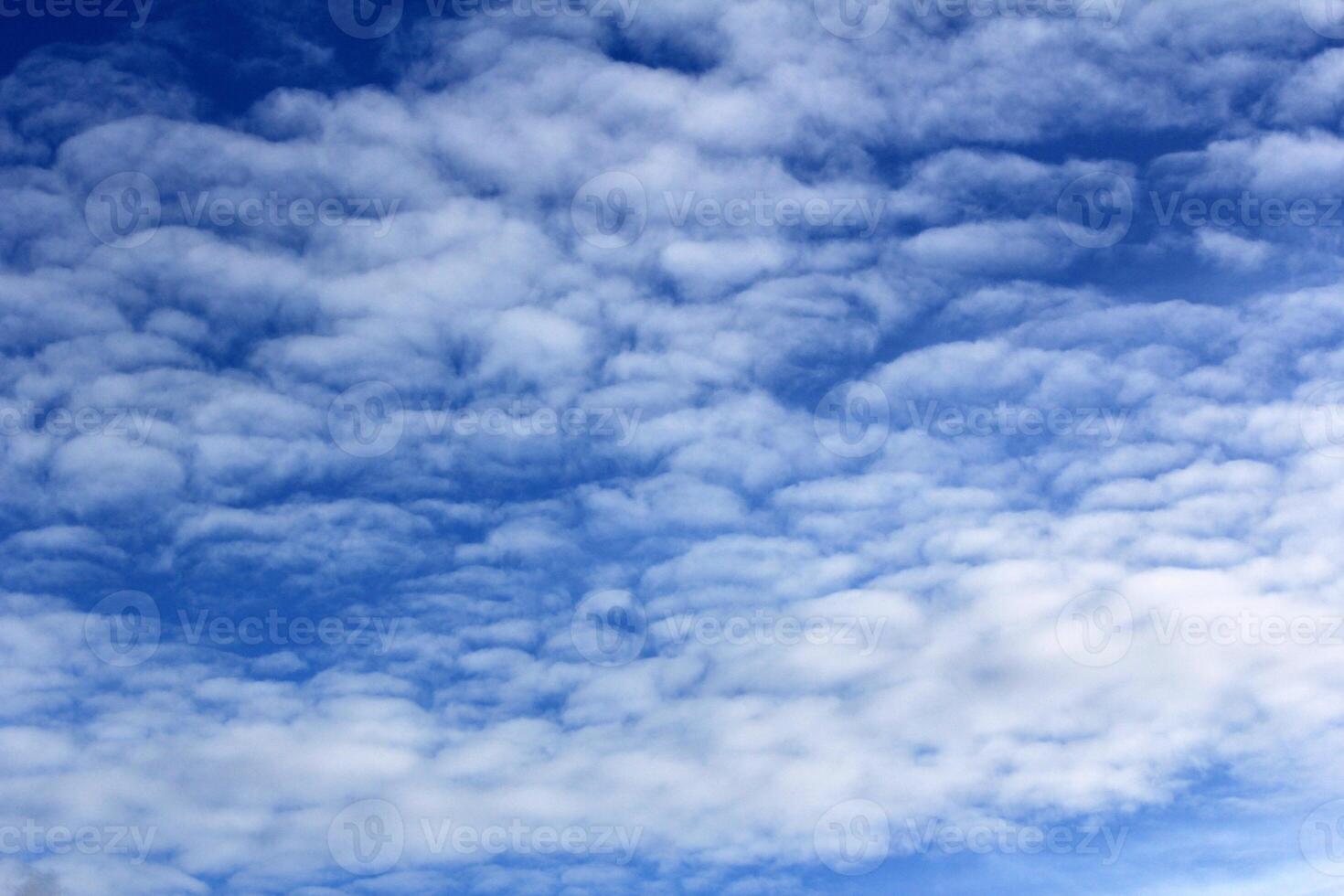 Beautiful Blue Sky with Soft, Fluffy White Clouds in a Serene Atmosphere photo
