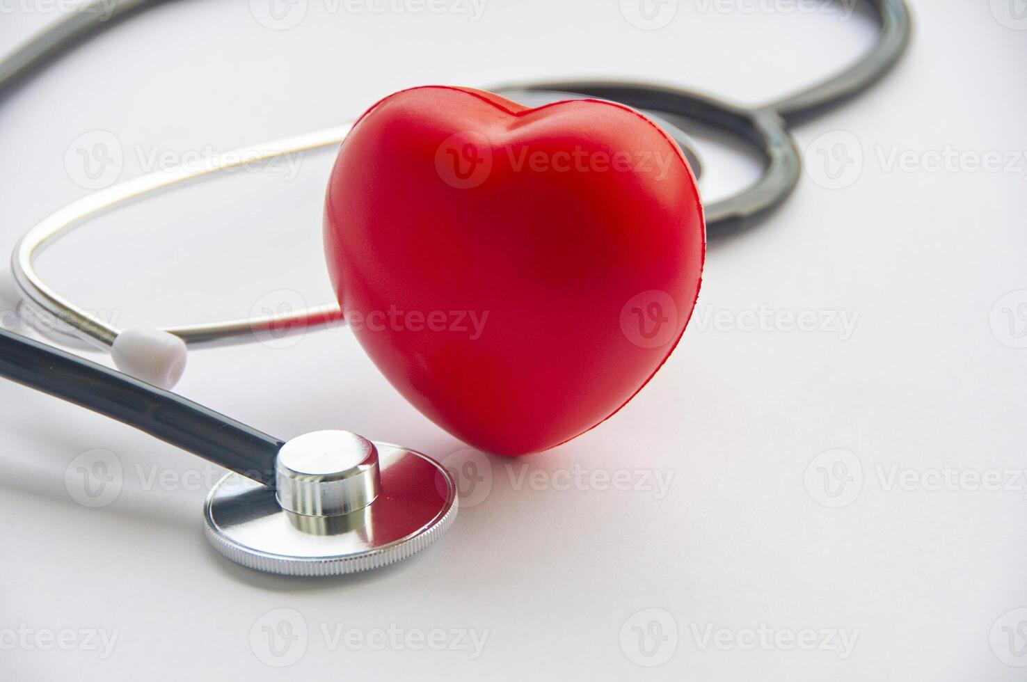 A view of stethoscope and a red heart shape with customizable space for text. Medical and health concept photo