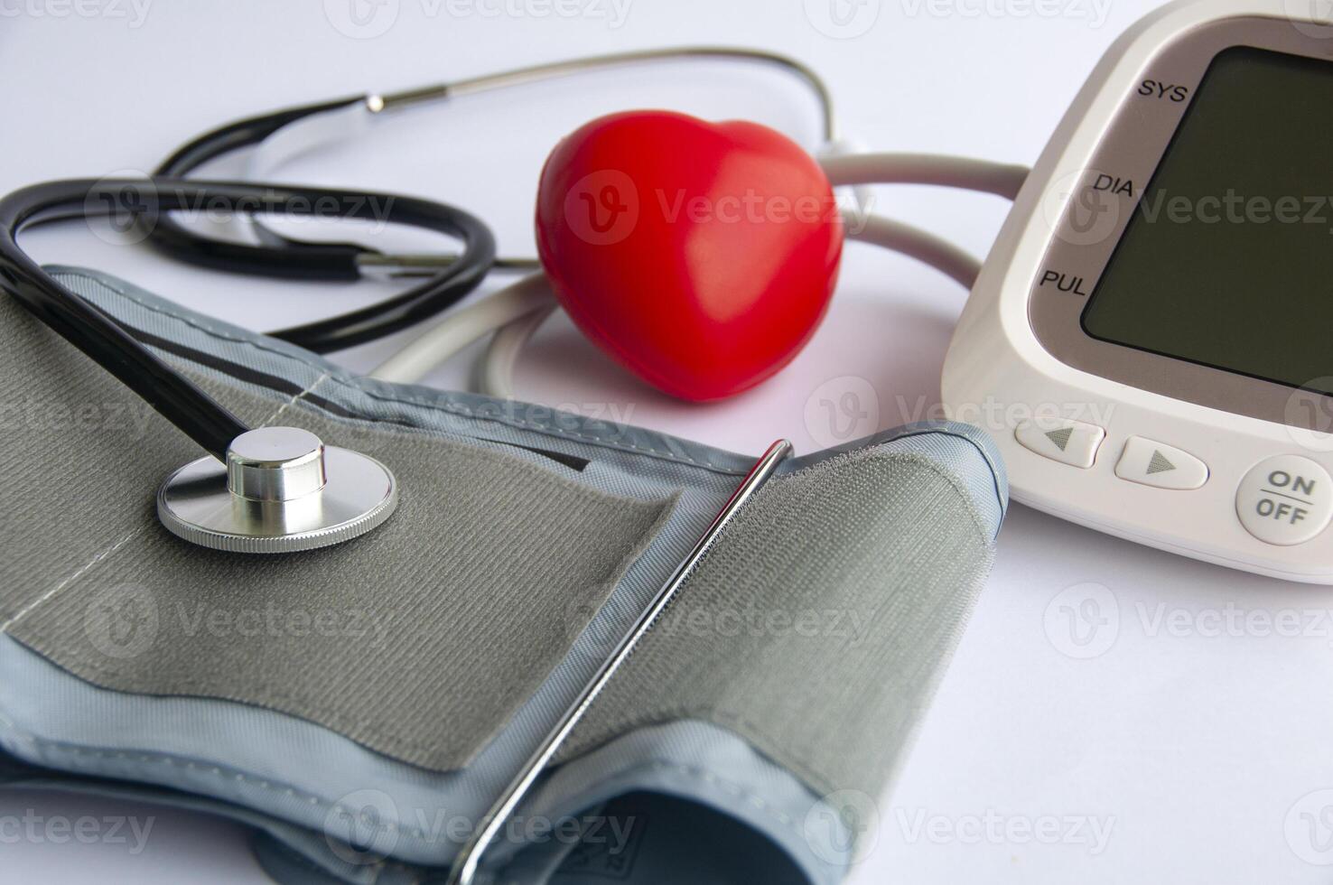 Side view of stethoscope, red heart shaped and blood pressure monitor with customizable space for text. Medical and health concept photo