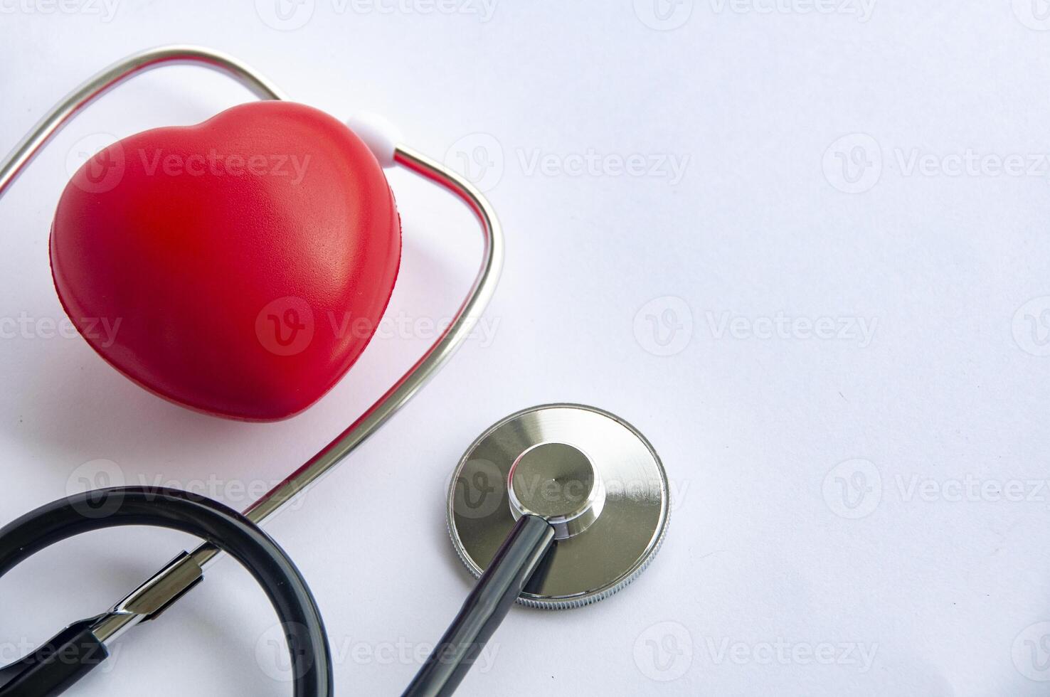 Top view of stethoscope and a red heart shaped with customizable space for text. Medical and health concept photo