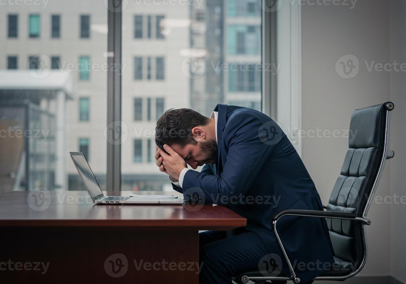 Man with headache holding his head in the office for Jobless man concept 1 photo