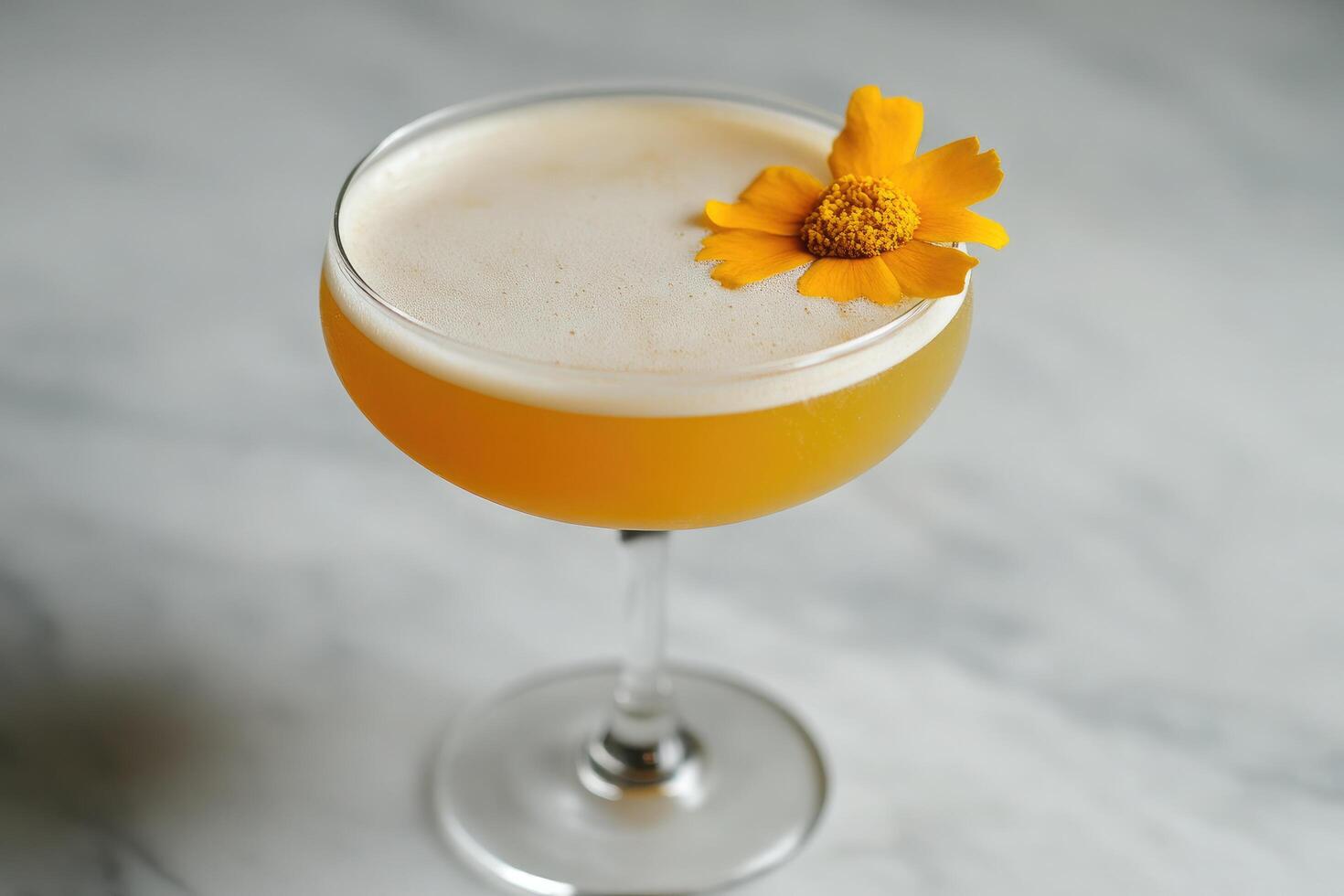 A yellow drink with a flower on top photo