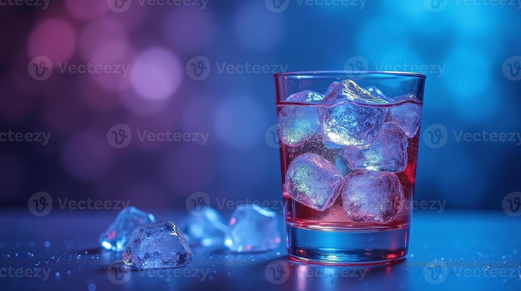A glass of refreshing liquid adorned with ice cubes against a bokeh backdrop. photo