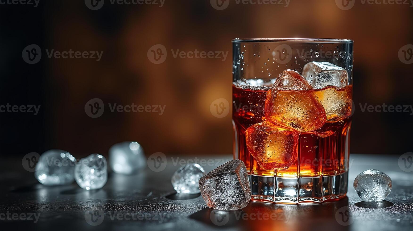 A glass filled with amber liquid and ice cubes, set against a softly blurred backdrop. photo