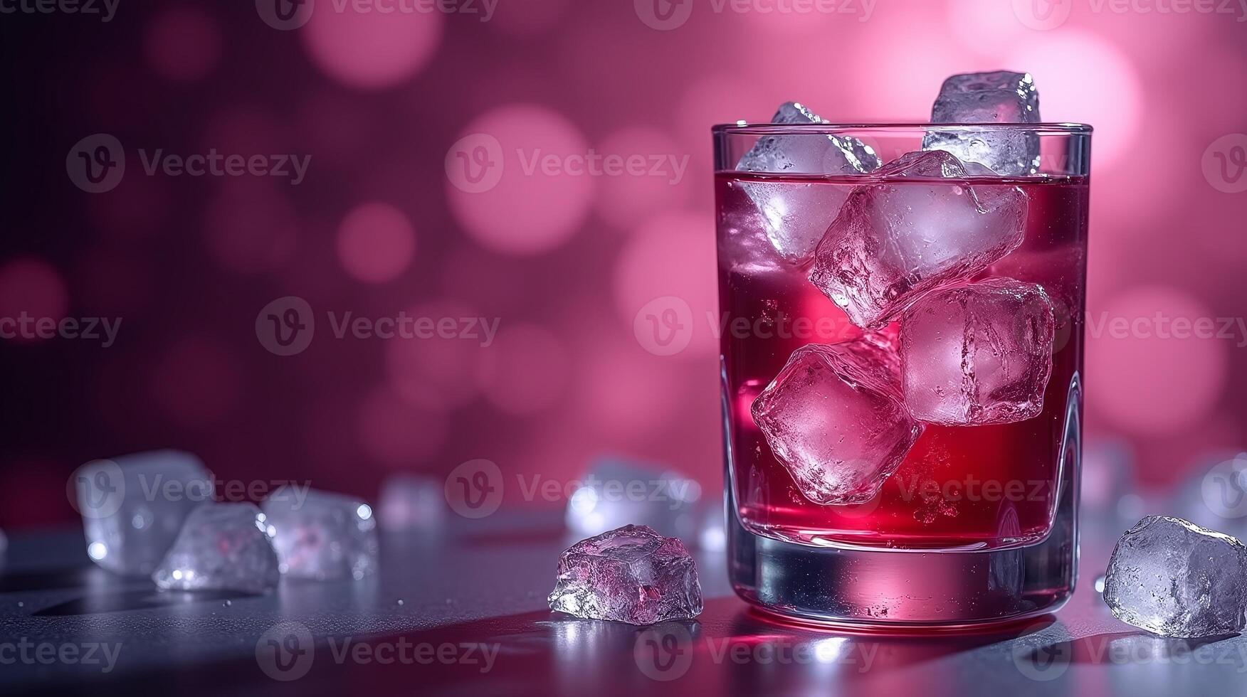 A vibrant red beverage in a glass, surrounded by ice cubes against a bokeh background. photo