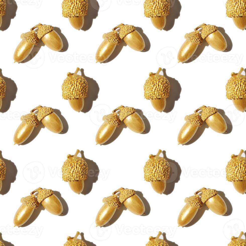 Autumn seamless pattern with golden painted acorns oak tree isolated on white background. Autumnal Still life image with natural materials. Autumn, fall concept. Repeat print top view, sunlight photo