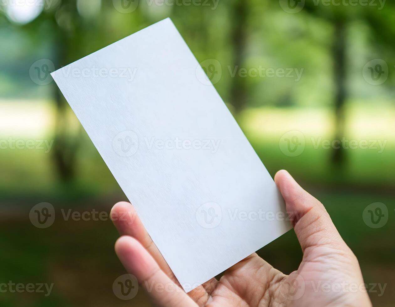 Close-Up of Hand Holding Empty Sheet of Paper photo