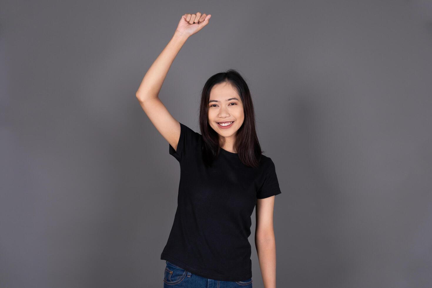 Young Girl Excitedly Raising Her Hand with Joy and Enthusiasm Isolated photo