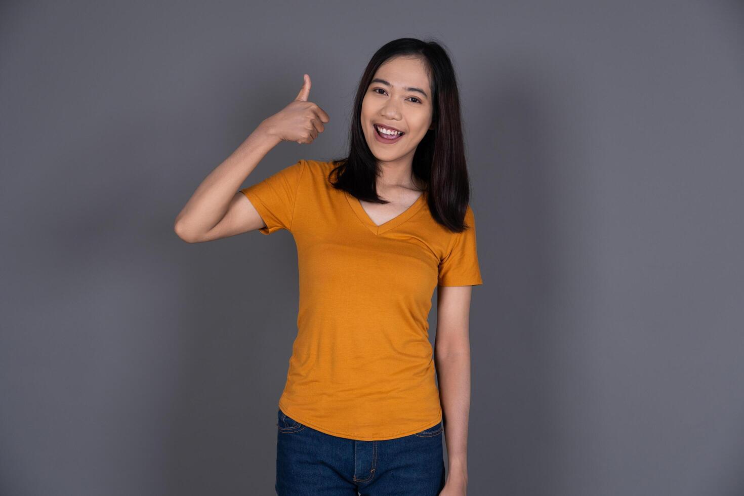 Portrait of a Young Confident Girl Giving a Thumbs Up in Approval Isolated photo