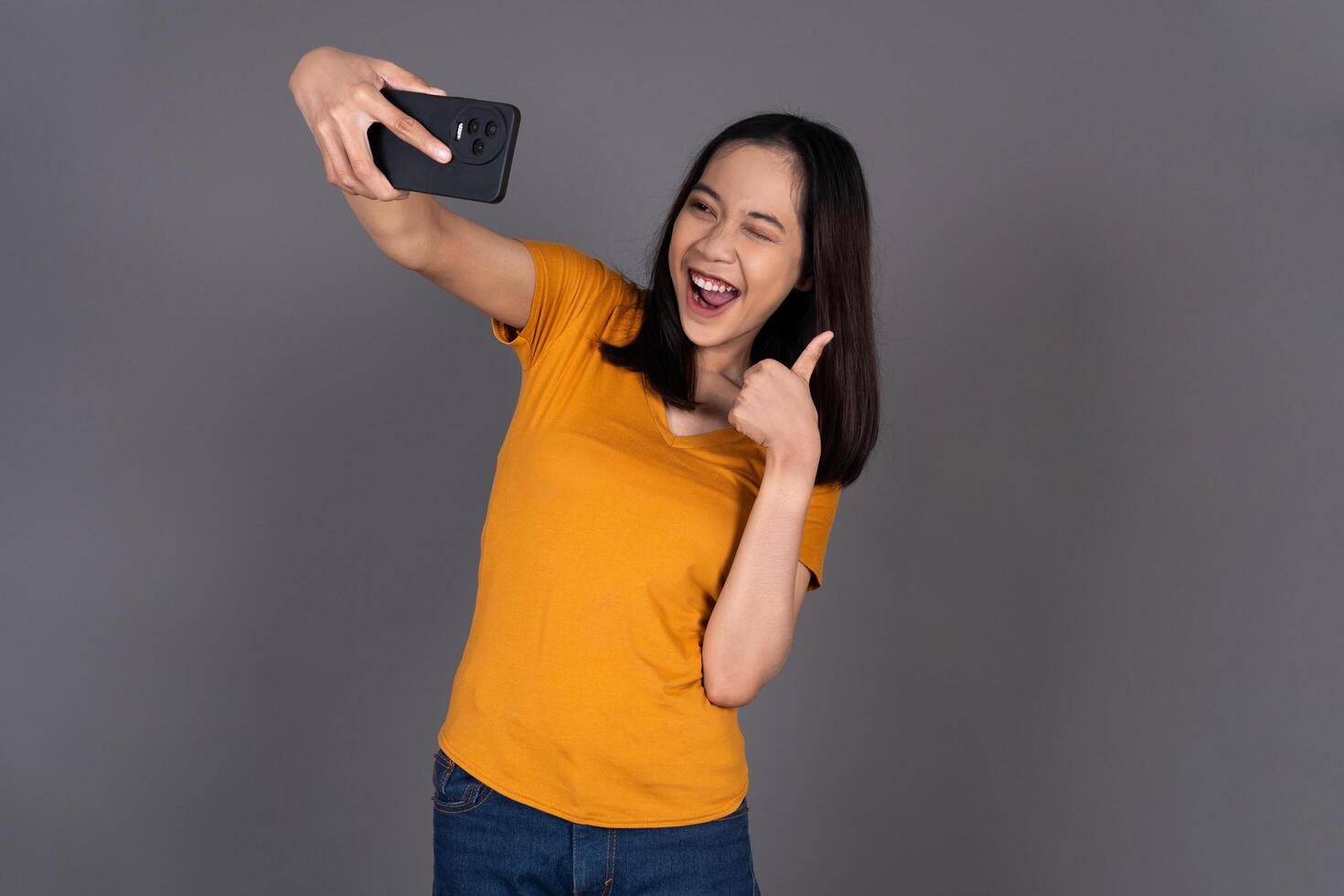 Close-Up of a Woman Smiling Happily While Taking a Selfie Isolated Background photo