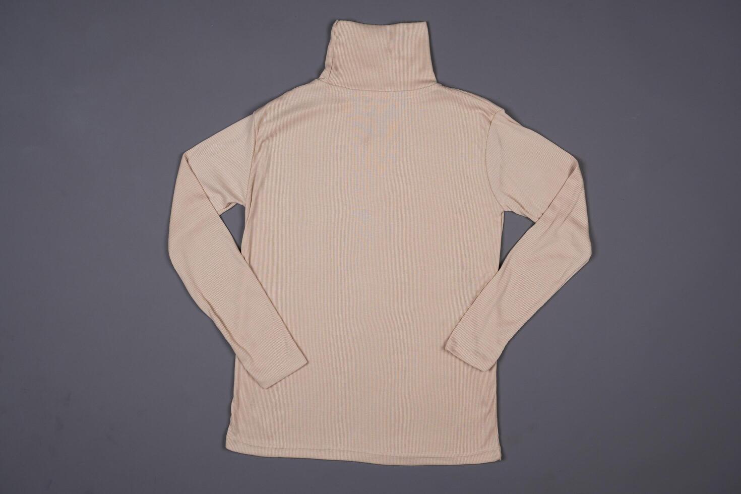 Beige knit t-shirt on a grey background photo