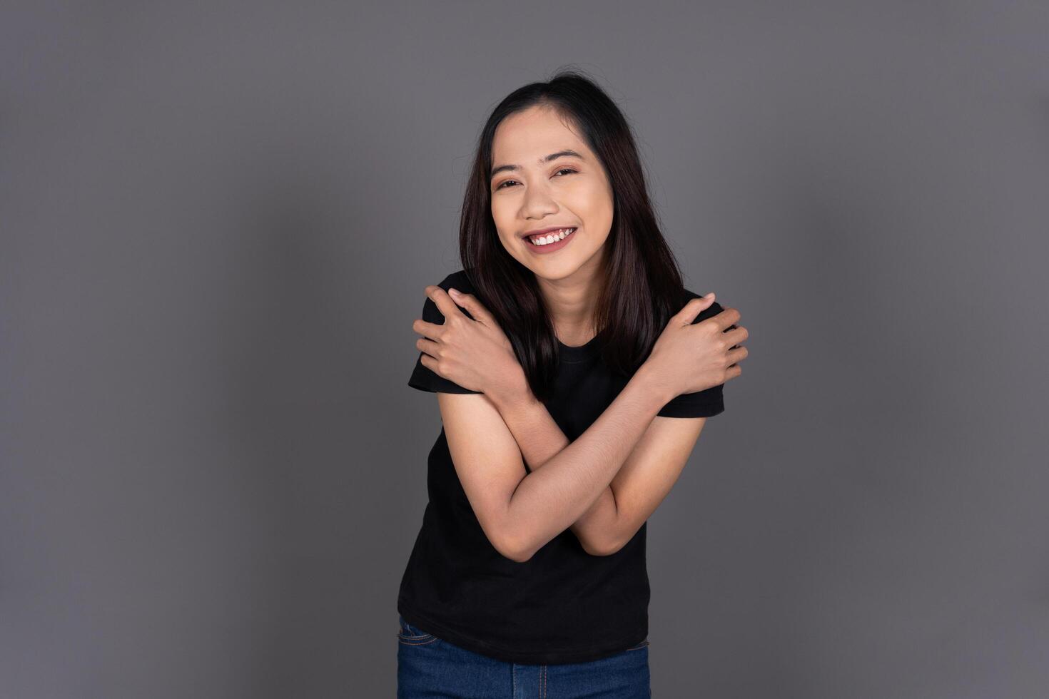 Portrait of a Girl Hugging Herself, Smiling with Self-Love and Happiness Isolated photo
