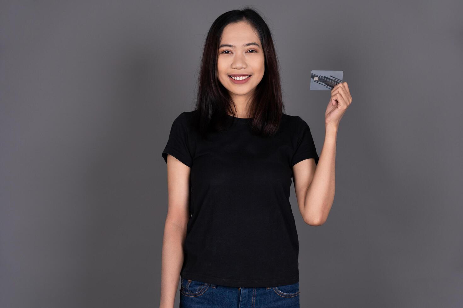 Portrait of a Girl Smiling While Holding a Credit Card photo