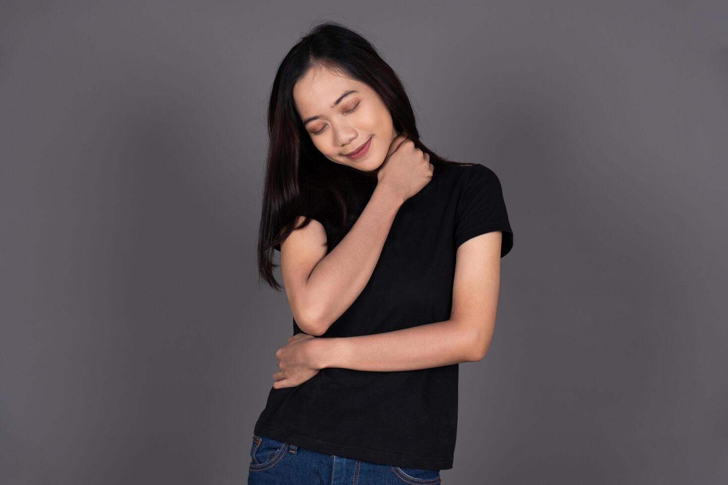 Portrait of a Female Hugging Herself, Smiling with Self-Love and Happiness Isolated photo