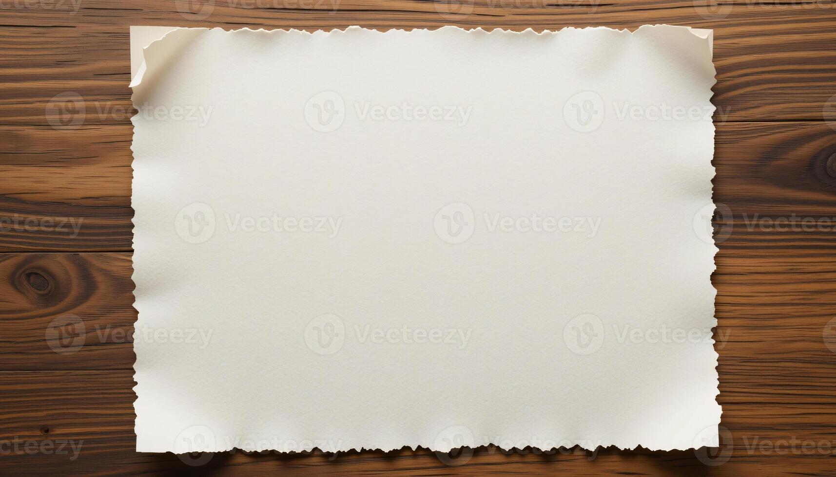 Empty white paper, slightly torn paper, on wooden desk background photo