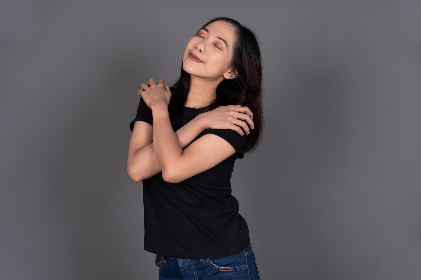 Portrait of a Girl Hugging Herself, Smiling with Self-Love and Happiness Isolated Background photo