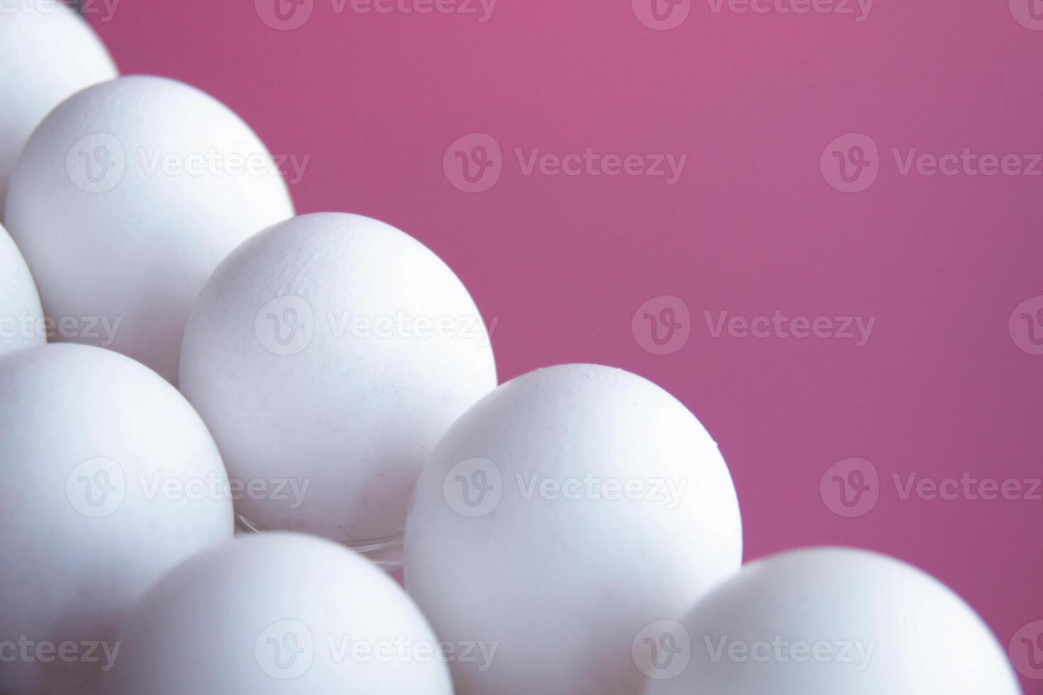 White Eggs arranged Diagonal Line against Vibrant Pink background. Minimalist composition highlights contrast and simplicity, emphasizes Clean Lines Diet Proteins Breakfast articles Easter themes photo