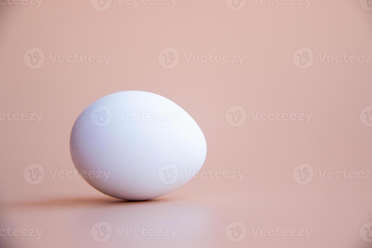 Minimalist White Egg on Neutral Background Tones Perfect for Kitchen Decor Culinary Themes Diet Proteins Breakfast articles Easter themes photo