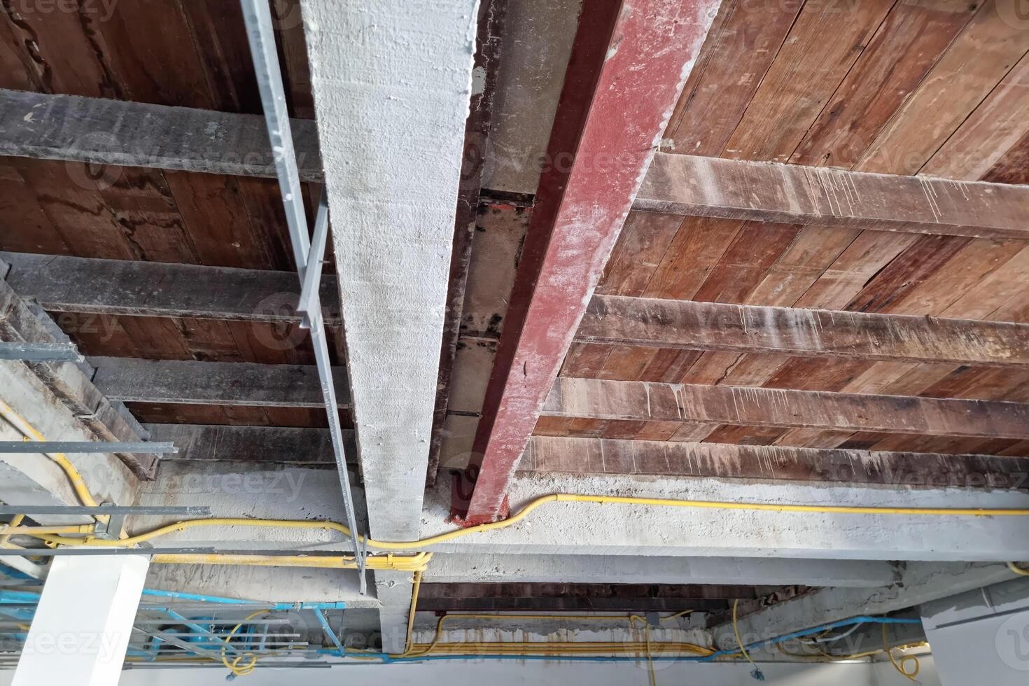 A ceiling with wood beams and pipes photo