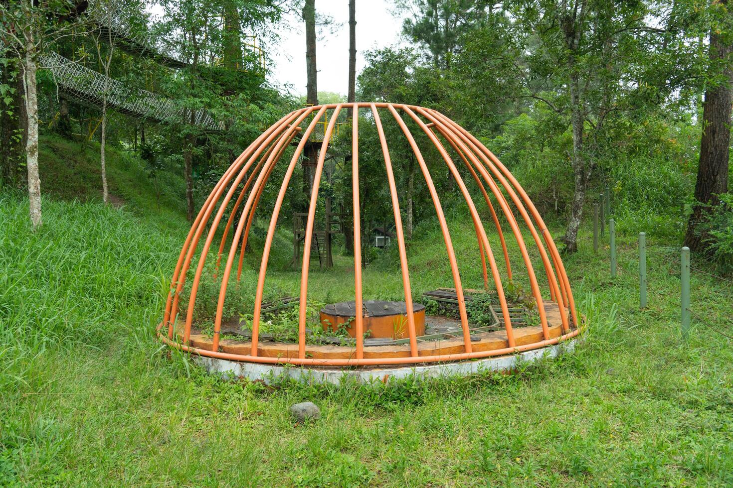 old abandoned playground. Abandoned Old children amusement park. Rusty and Poverty. Retro playground on the middle of forest photo