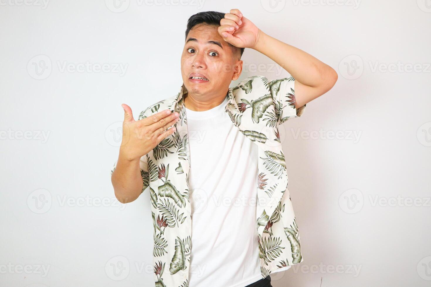 handsome of asian man feel hot isolated on white background in studio With copy space. photo