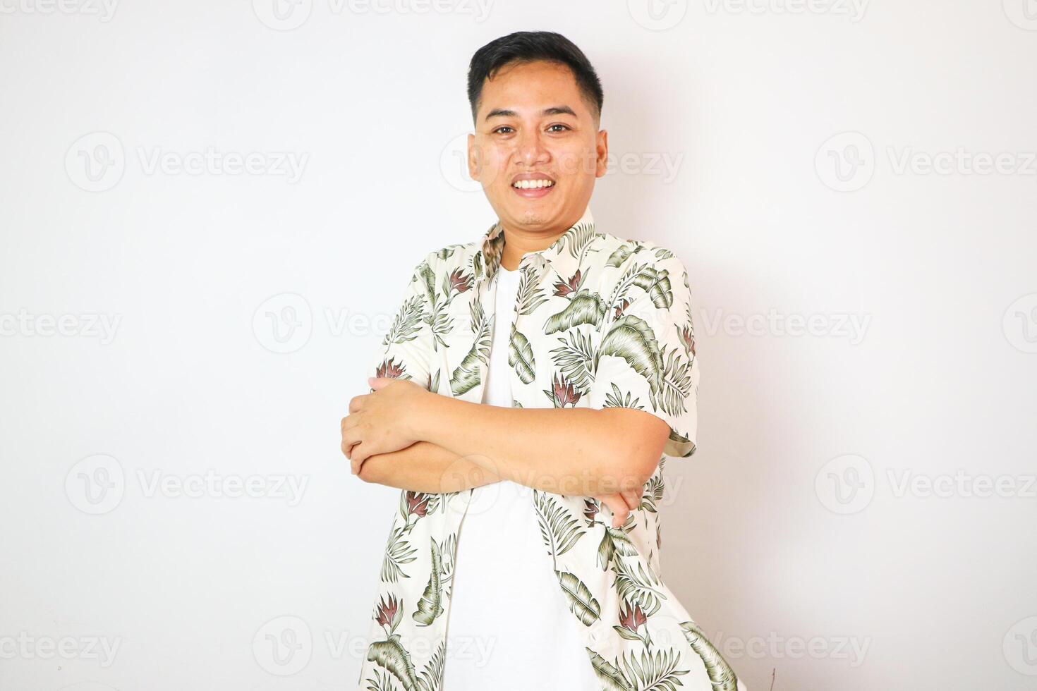 Asian man tourism cross arm happy smiling on the beach with beautiful ocean background copy space photo