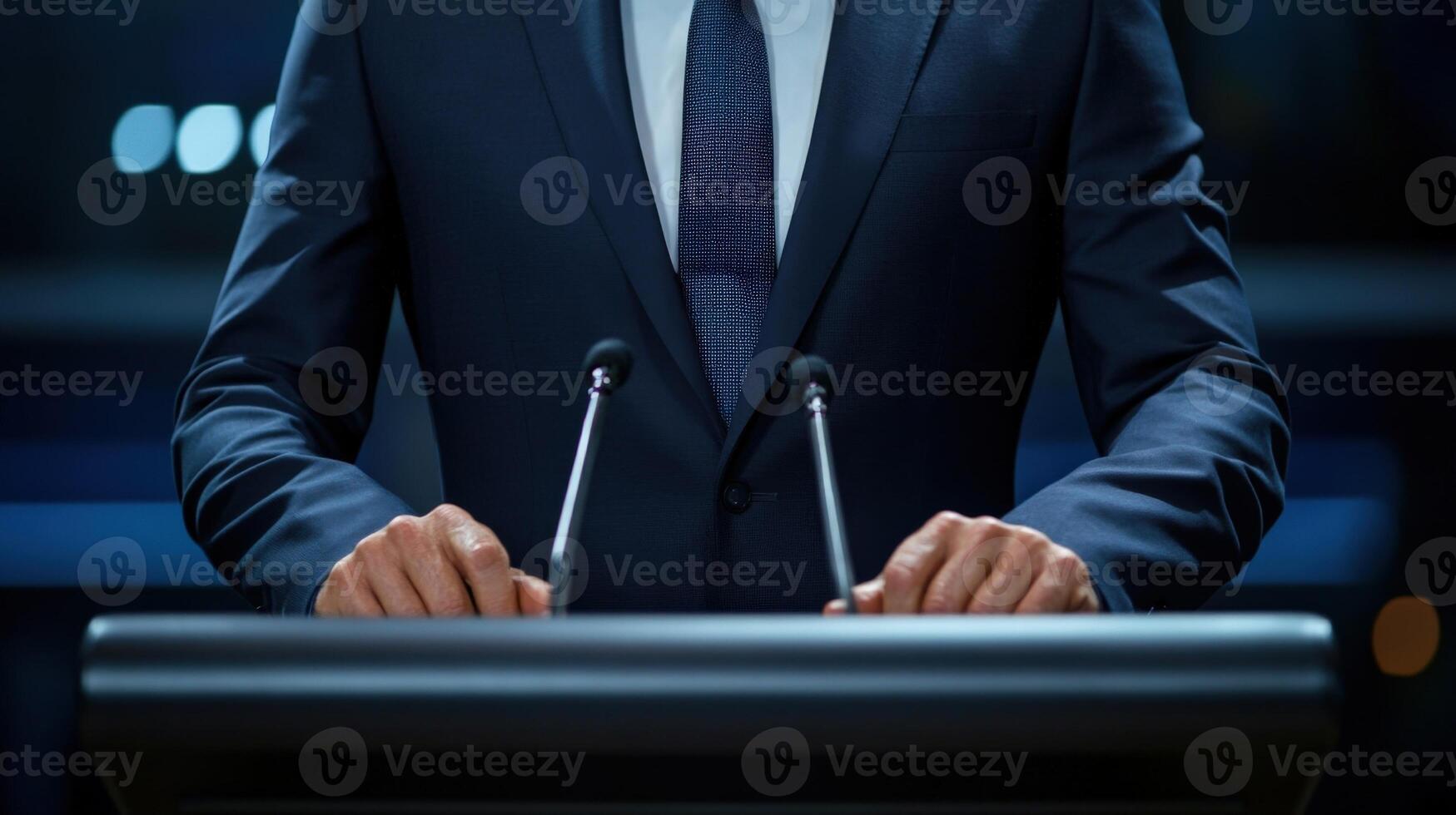 In a medium closeup the politicians intense gaze is framed by the structured lapels of their fitted suit conveying readiness and charisma. Their hands rest firmly on the podium reflectin photo