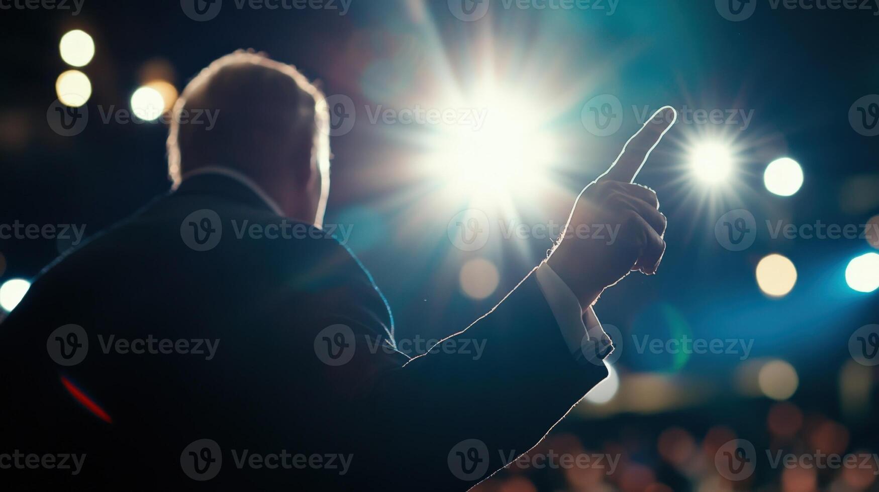 Politician giving a speech on stage pointing with finger photo