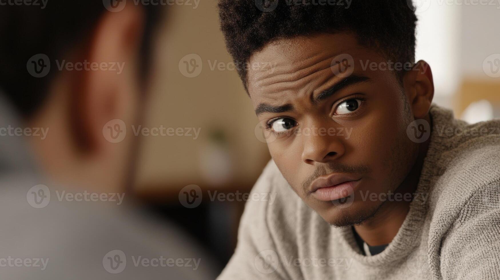Young politician listening attentively during meeting with concerned expression photo