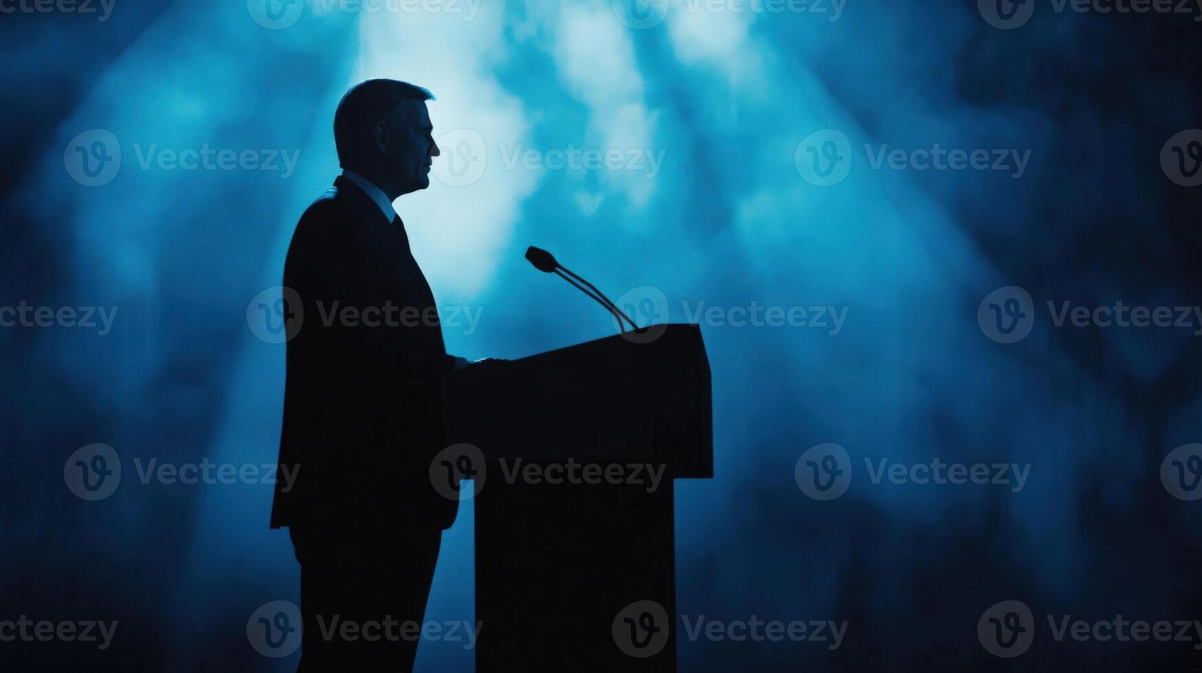 A confident politician delivers a speech at an elegant podium their facial features illuminated by soft light. The interplay of lighter and darker blue shades in the abstract backgroun photo