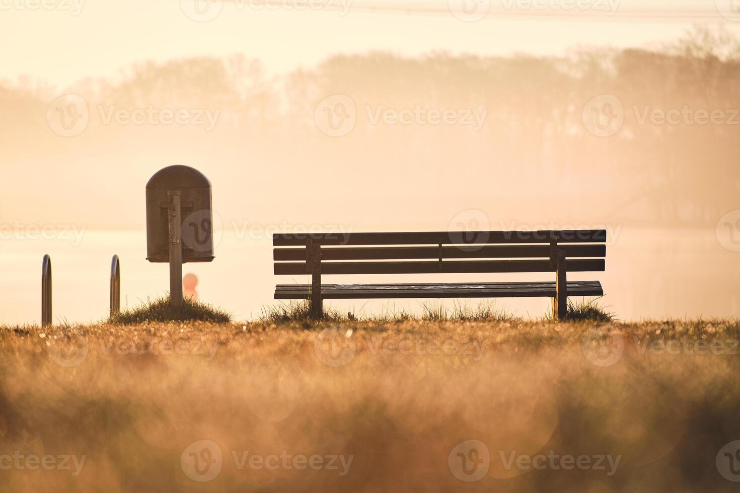 Bench at bathing area at lake in the morning photo