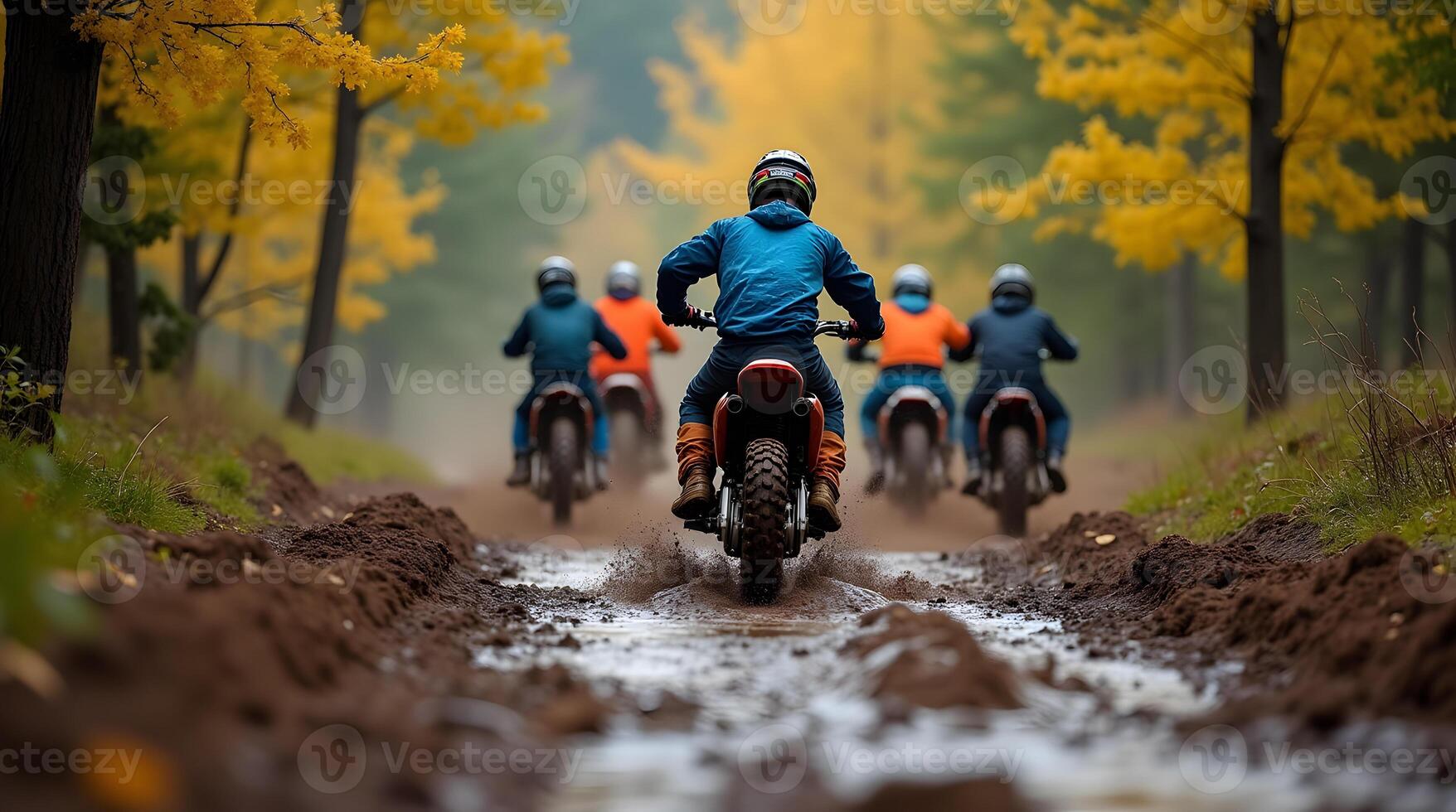 Four people riding dirt bikes on a muddy trail photo