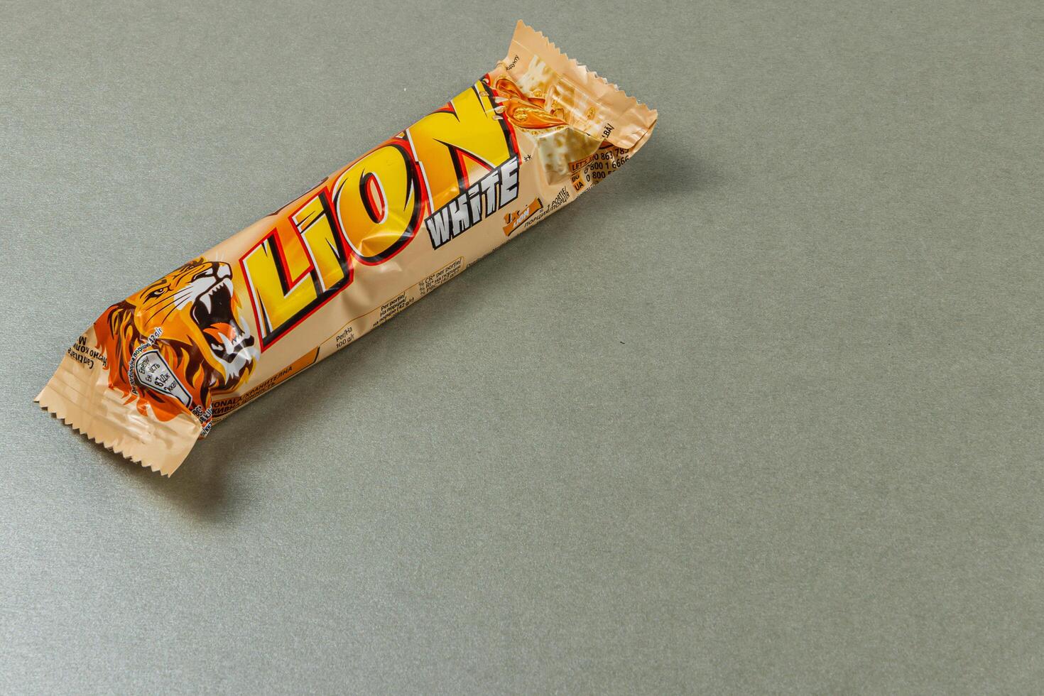 Lviv Ukraine 04.02.25 Exciting chocolate bar with lion branding on gray surface photo