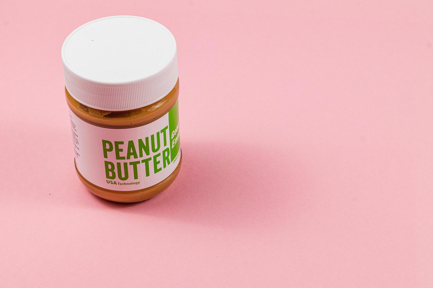 Lviv Ukraine 04.02.25 Peanut butter jar on a pink background photo