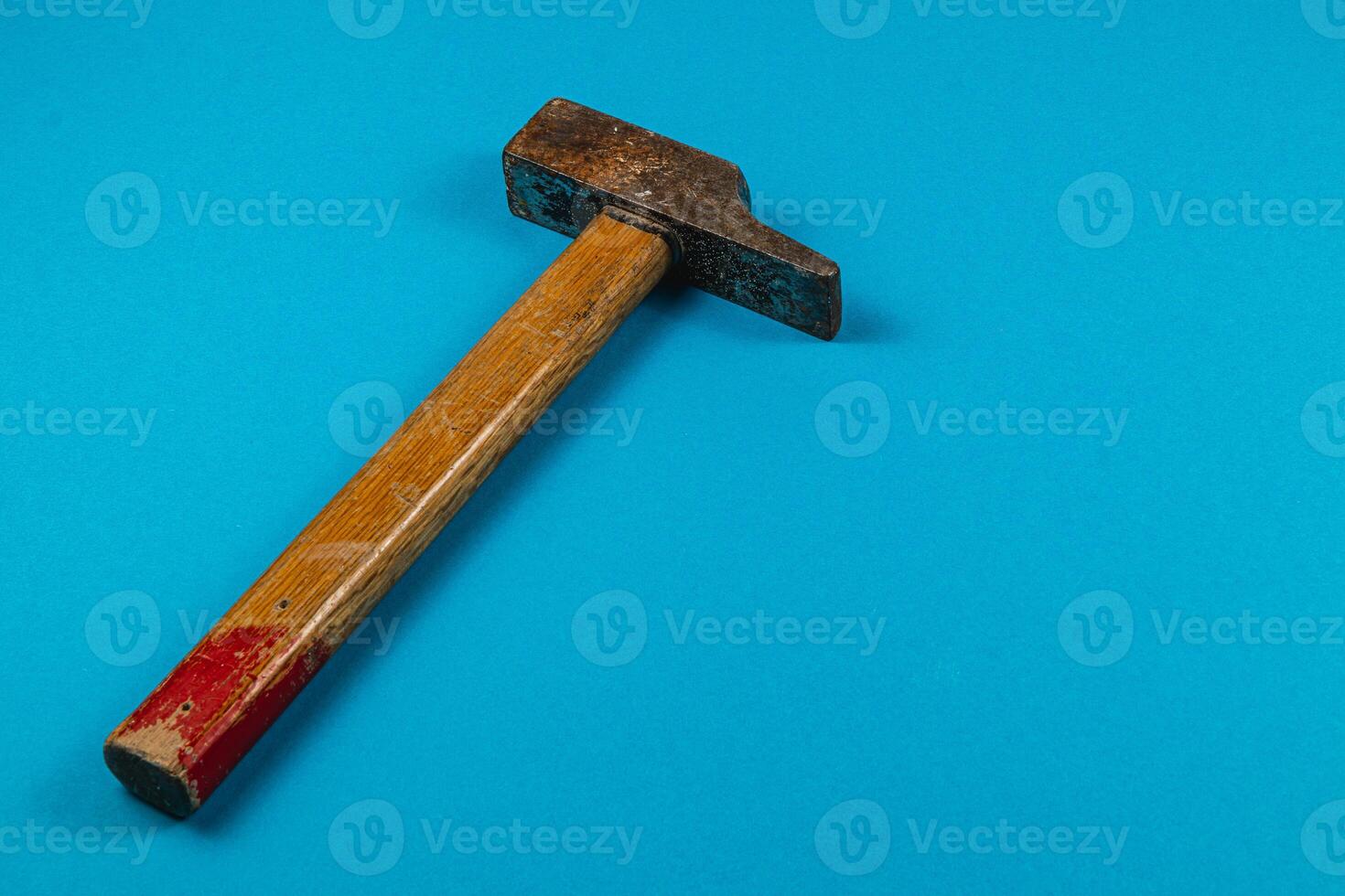 Tool resting on blue surface in a workshop setting photo