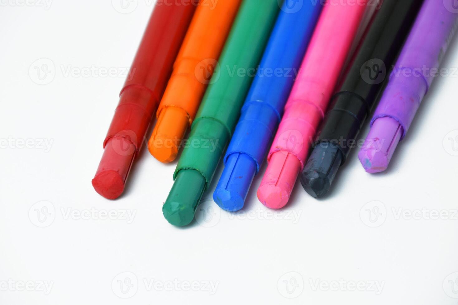 Multicolored Silky Crayons Neatly Arranged on White Background photo