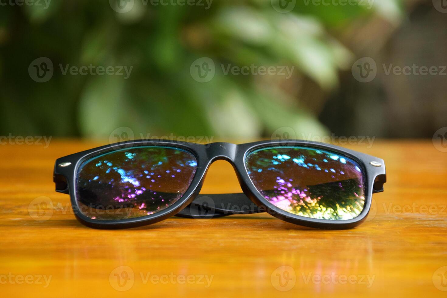 Fashionable Sunglasses Displayed on Natural Wood photo