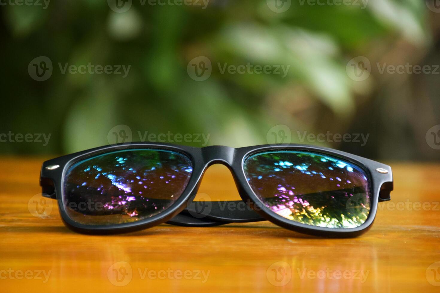 Modern Black Sunglasses on Rustic Wooden Background photo