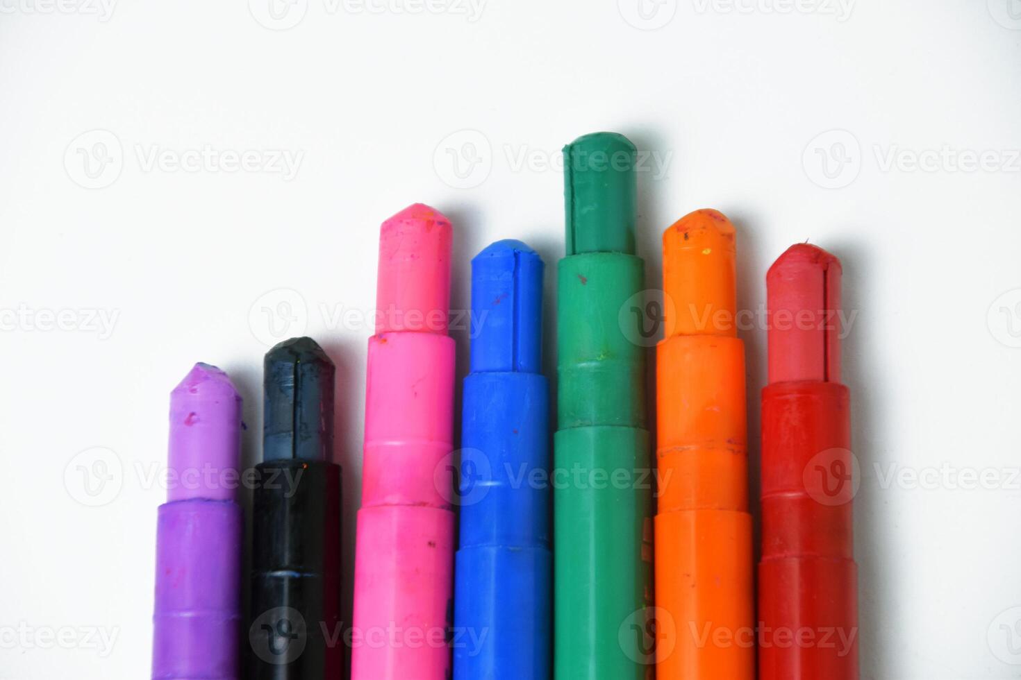 Silky Crayons in Multiple Colors Arranged on White photo