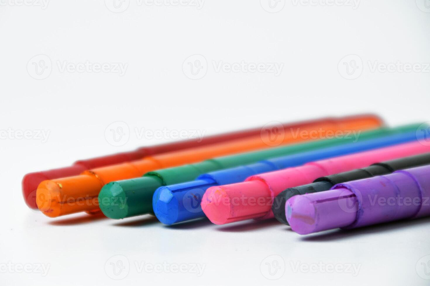 Smooth Colorful Crayons Arrangement on White photo