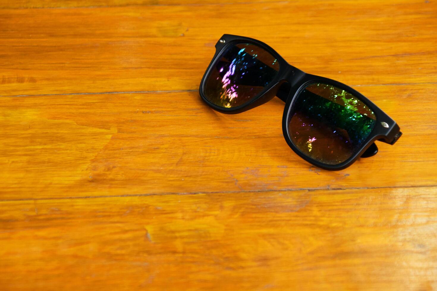 Chic Eyeglasses Resting on Natural Wood Surface photo