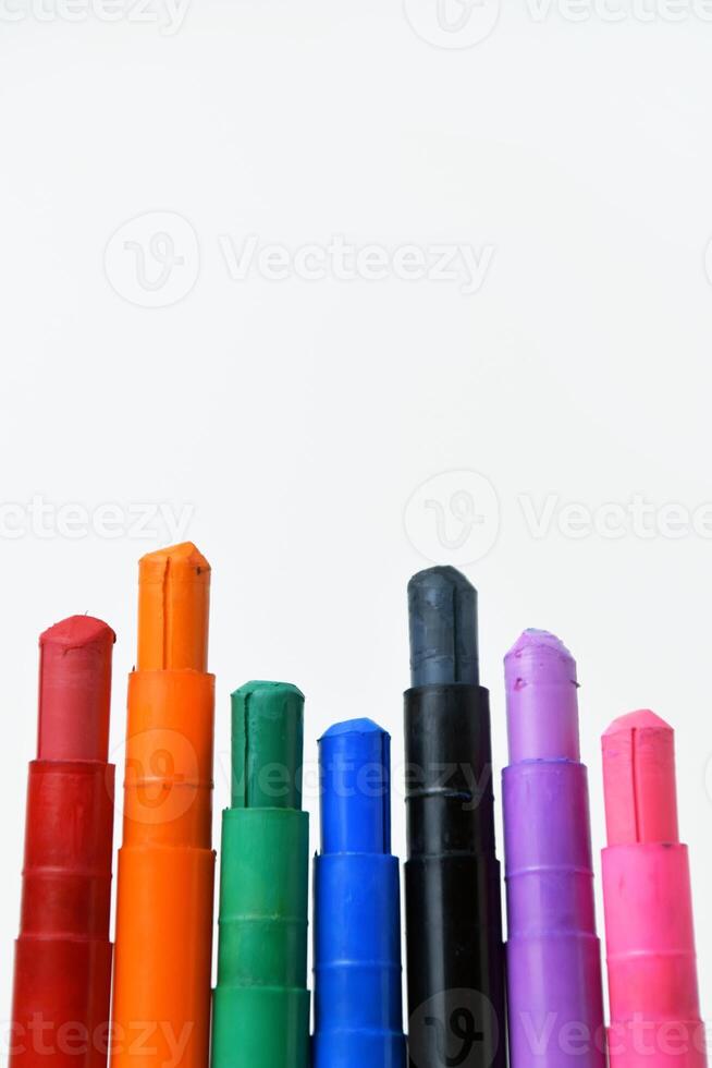 Colorful silky crayons on a white background photo
