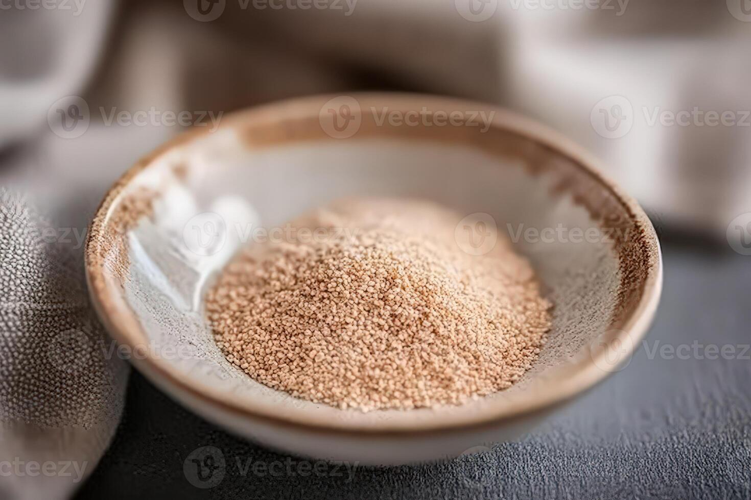 Psyllium husk in a bowl on a textured surface photo