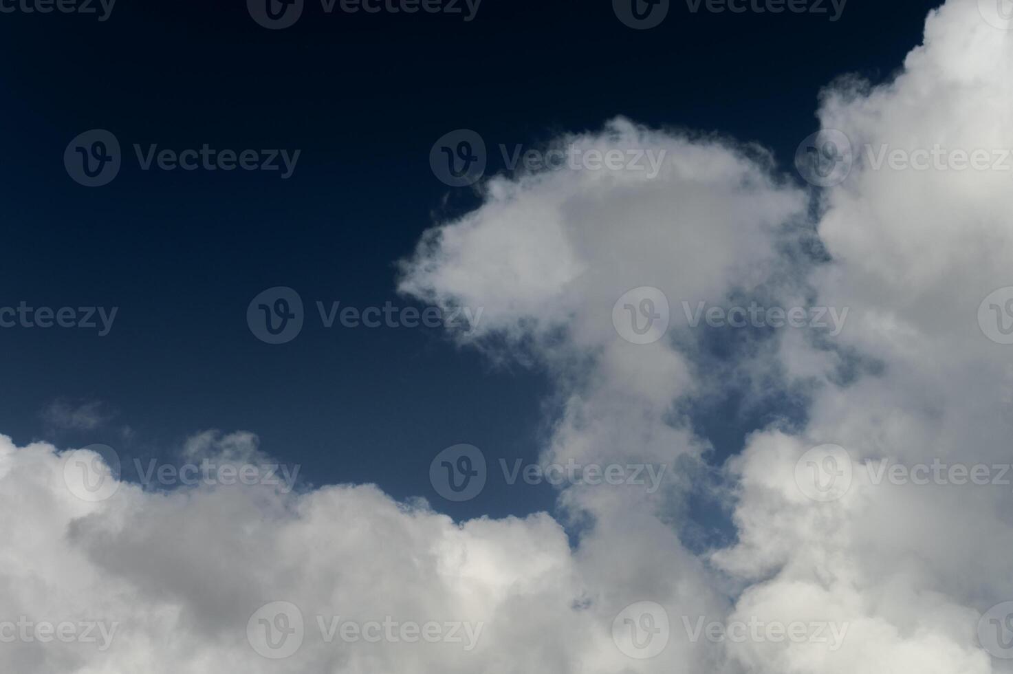 Cloud that is in the blue sky. Close-up of the serene sky above photo
