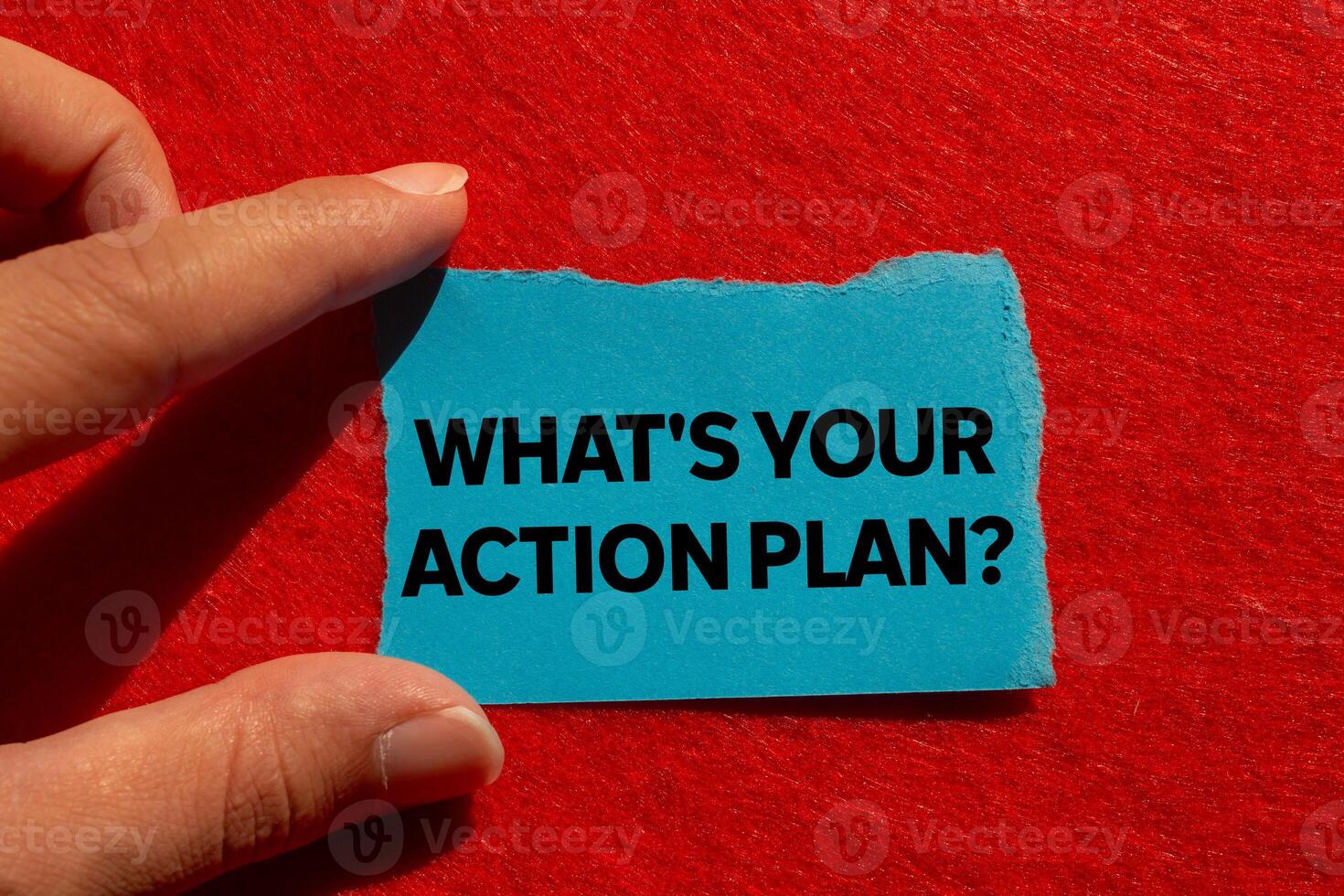What is your action plan message written on ripped torn blue paper on red background. Conceptual what is your action plan symbol. Copy space. photo