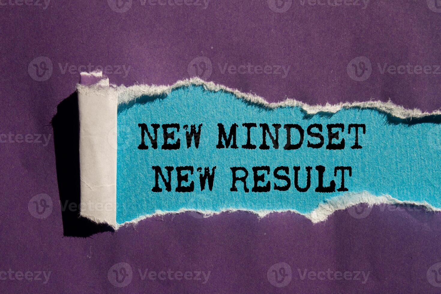 New mindset new result message written on ripped torn purple paper on blue background. Conceptual new mindset new result symbol. Copy space. photo