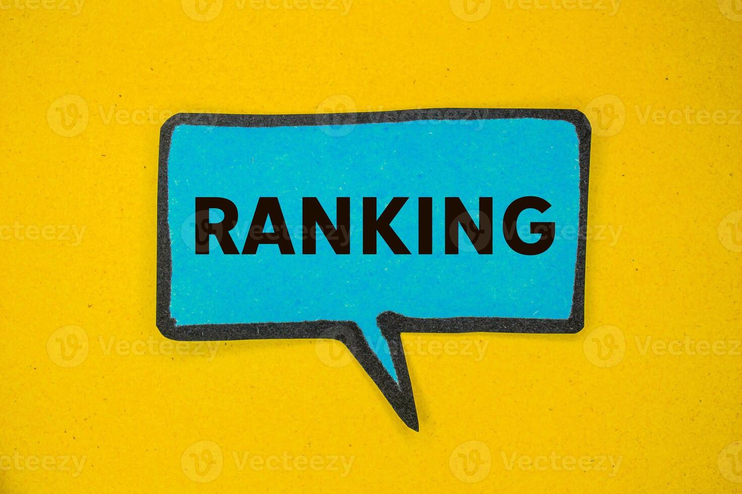 Ranking message written on blue paper speech bubble on yellow background. Conceptual ranking symbol. Copy space. photo